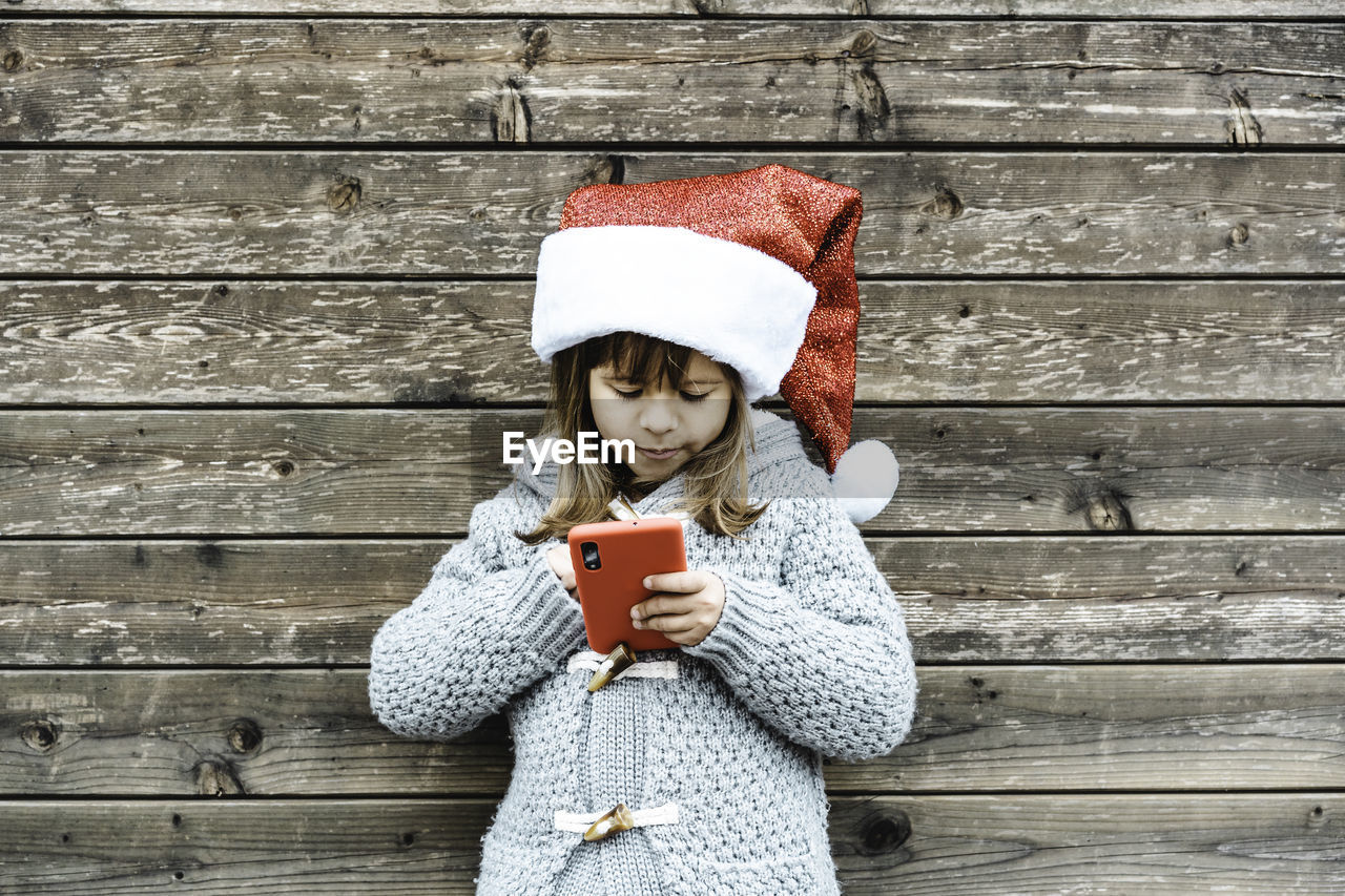 high angle view of woman holding gift on wooden table