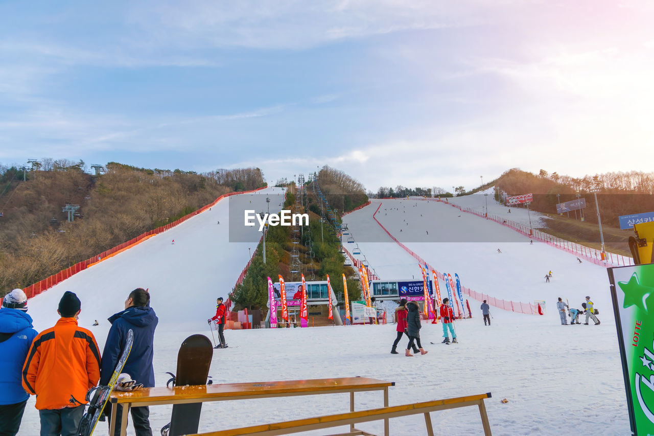 PEOPLE ON SNOW COVERED LANDSCAPE