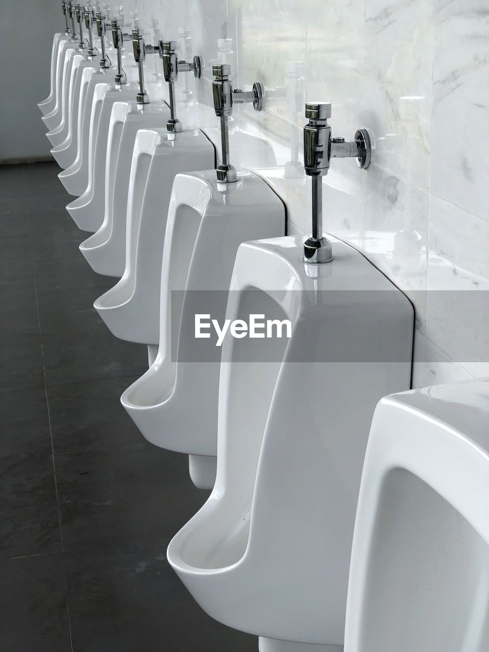 Close-up of empty urinals