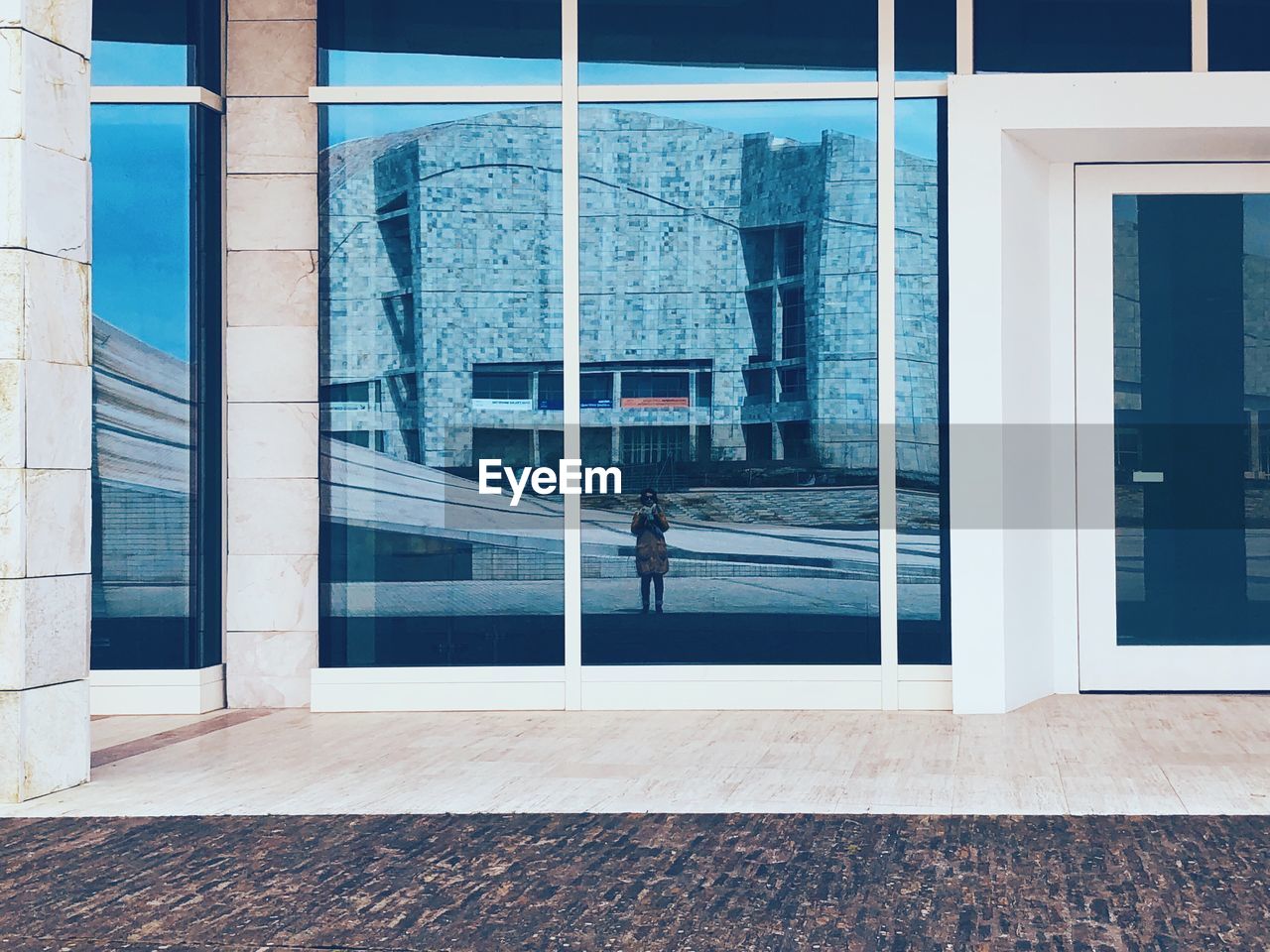 BUILDINGS SEEN THROUGH GLASS WINDOW