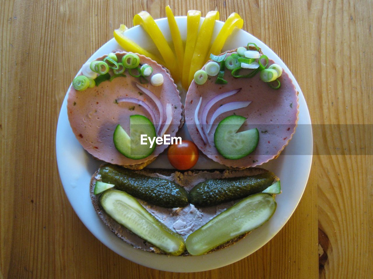 High angle view of anthropomorphic face made from bread and vegetables