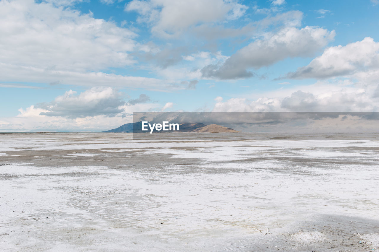 Scenic view of sea against cloudy sky