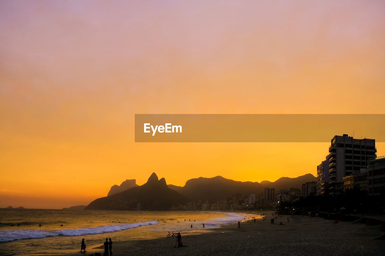 SCENIC VIEW OF BEACH AT SUNSET