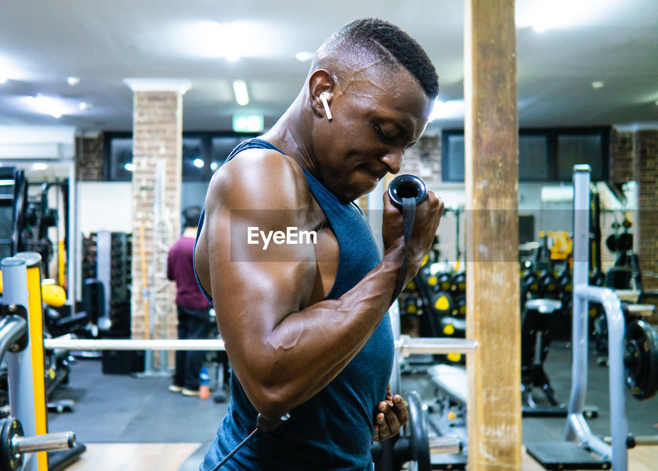 Side view of man exercising in gym