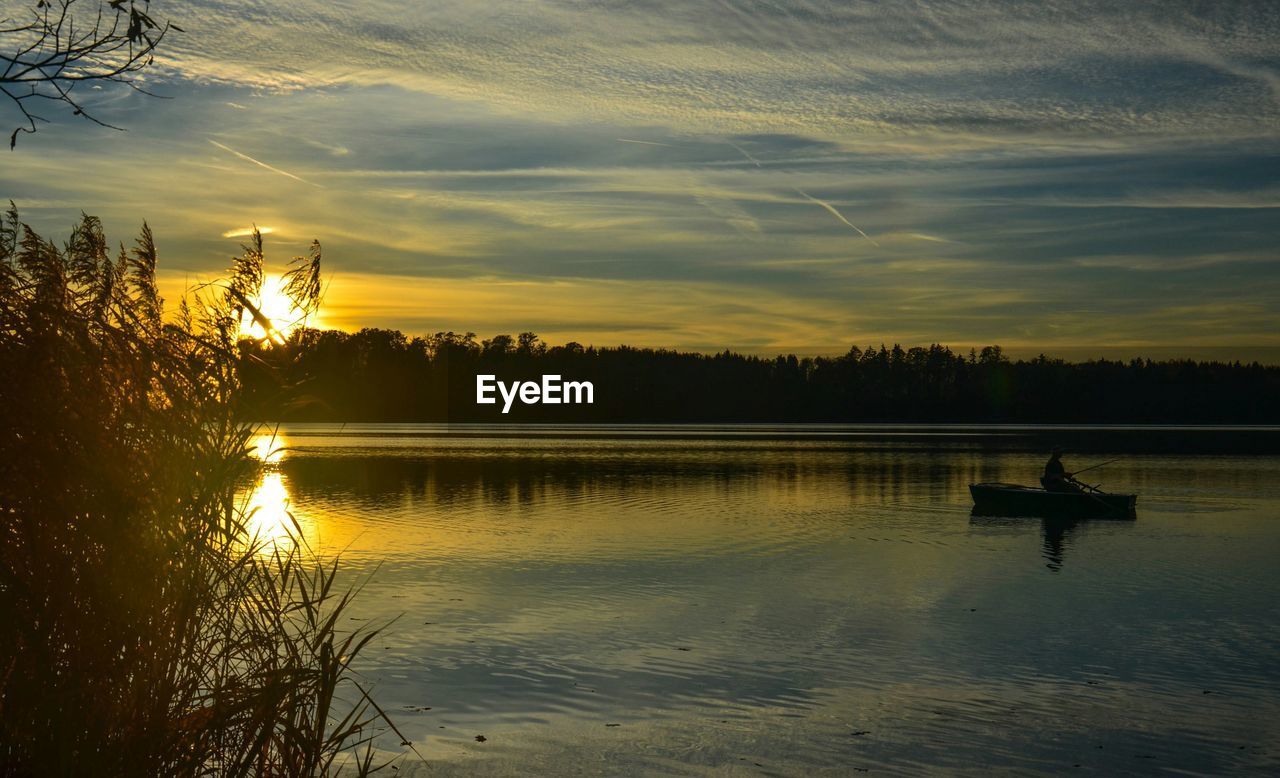 Scenic view of lake against sky during sunset