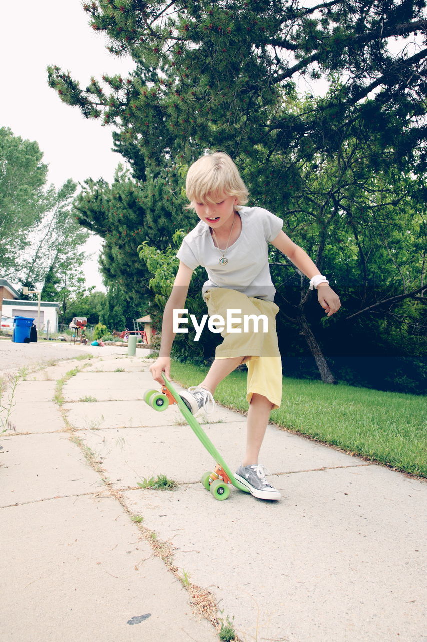 Full length of boy with skateboard