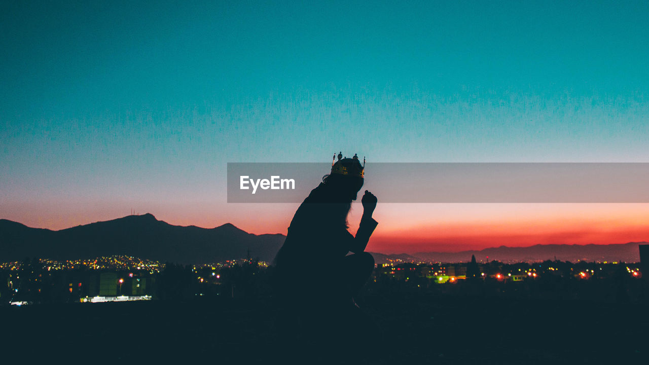 Silhouette man against sky during sunset