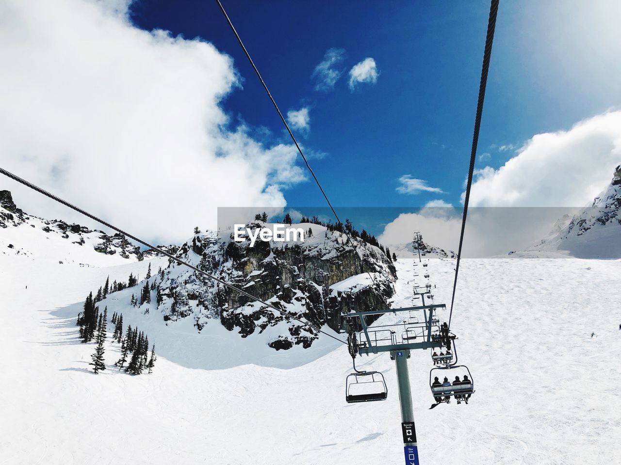 Low angle view of ski lift against snowcapped mountain