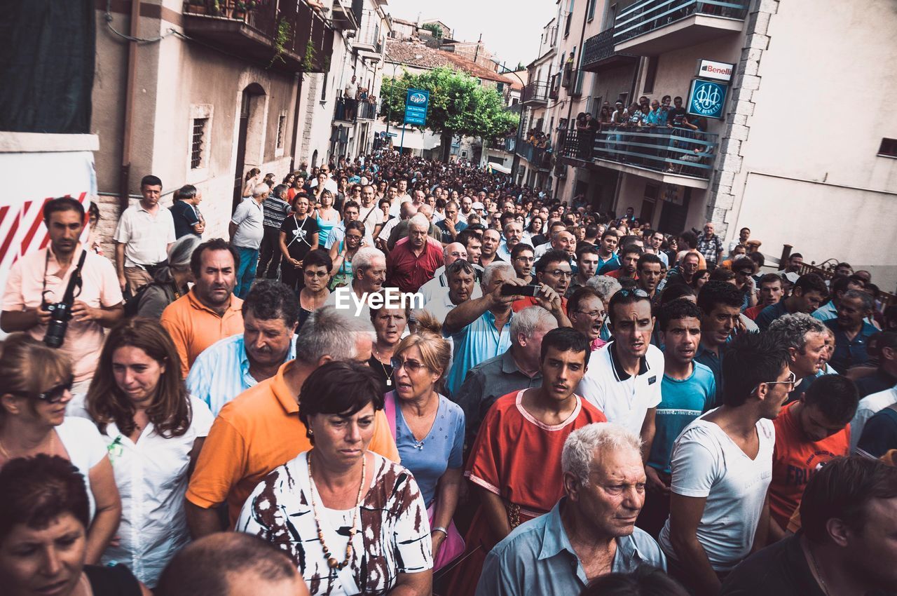 GROUP OF PEOPLE ON STREET IN CITY