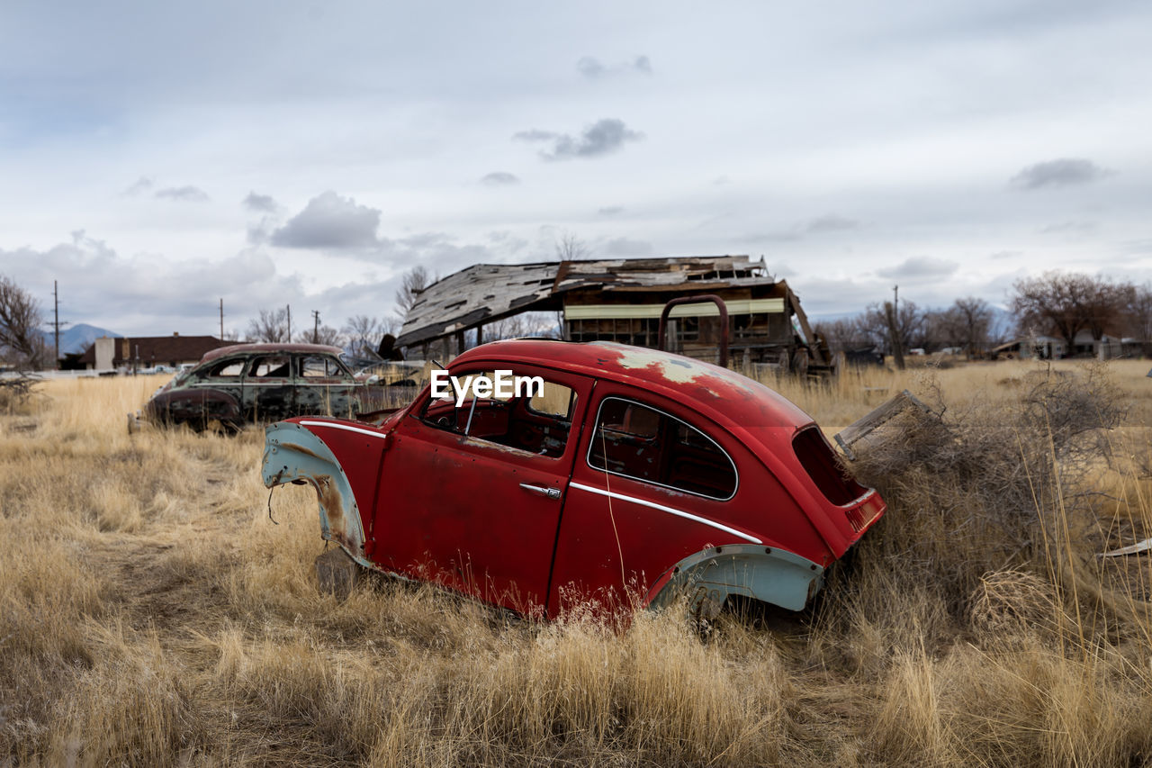 ABANDONED VINTAGE CAR ON FIELD