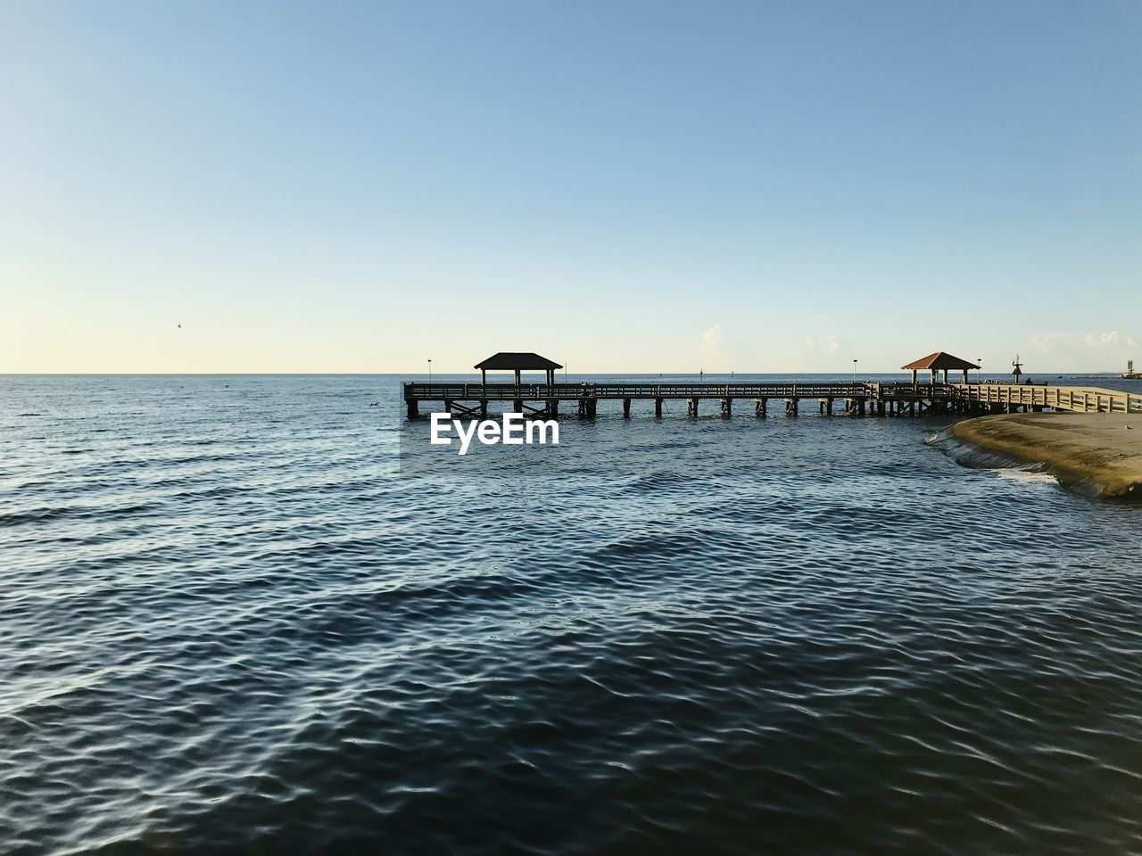 Scenic view of sea against clear sky during sunset