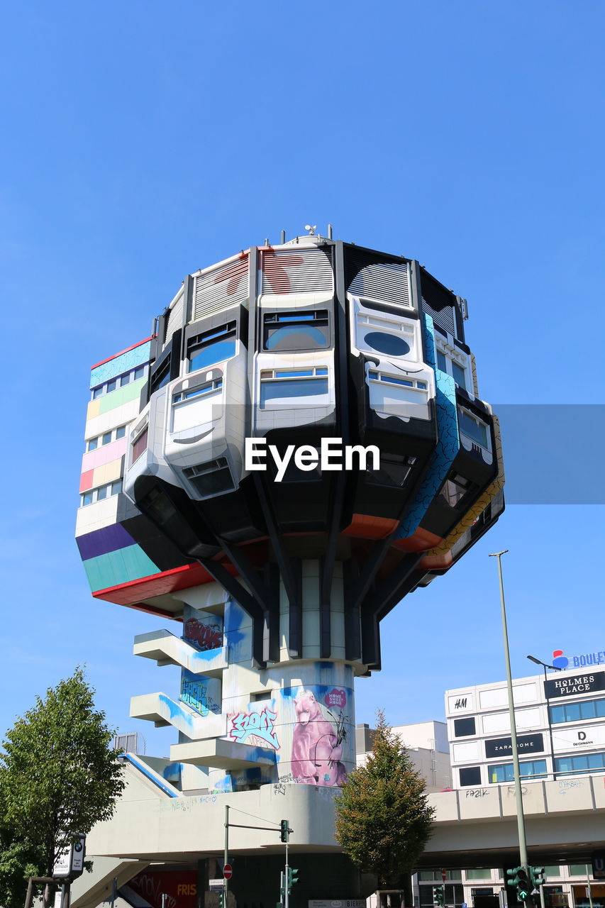 LOW ANGLE VIEW OF BUILT STRUCTURES AGAINST BLUE SKY