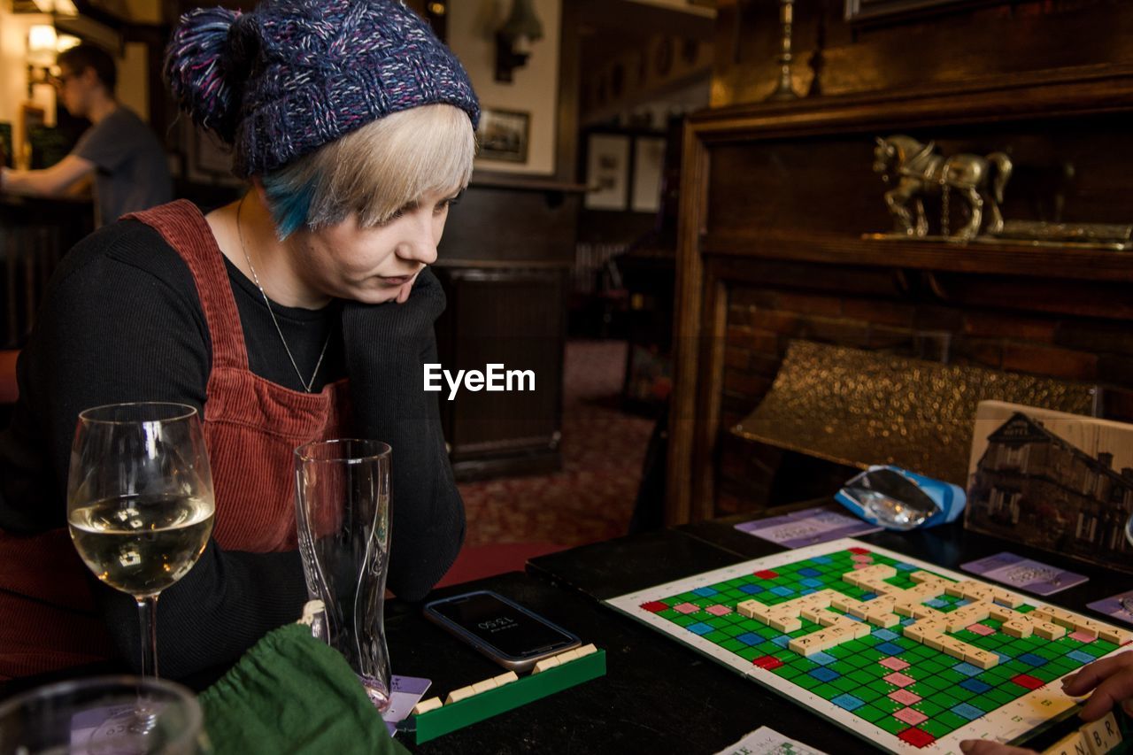 Woman looking at scrabble