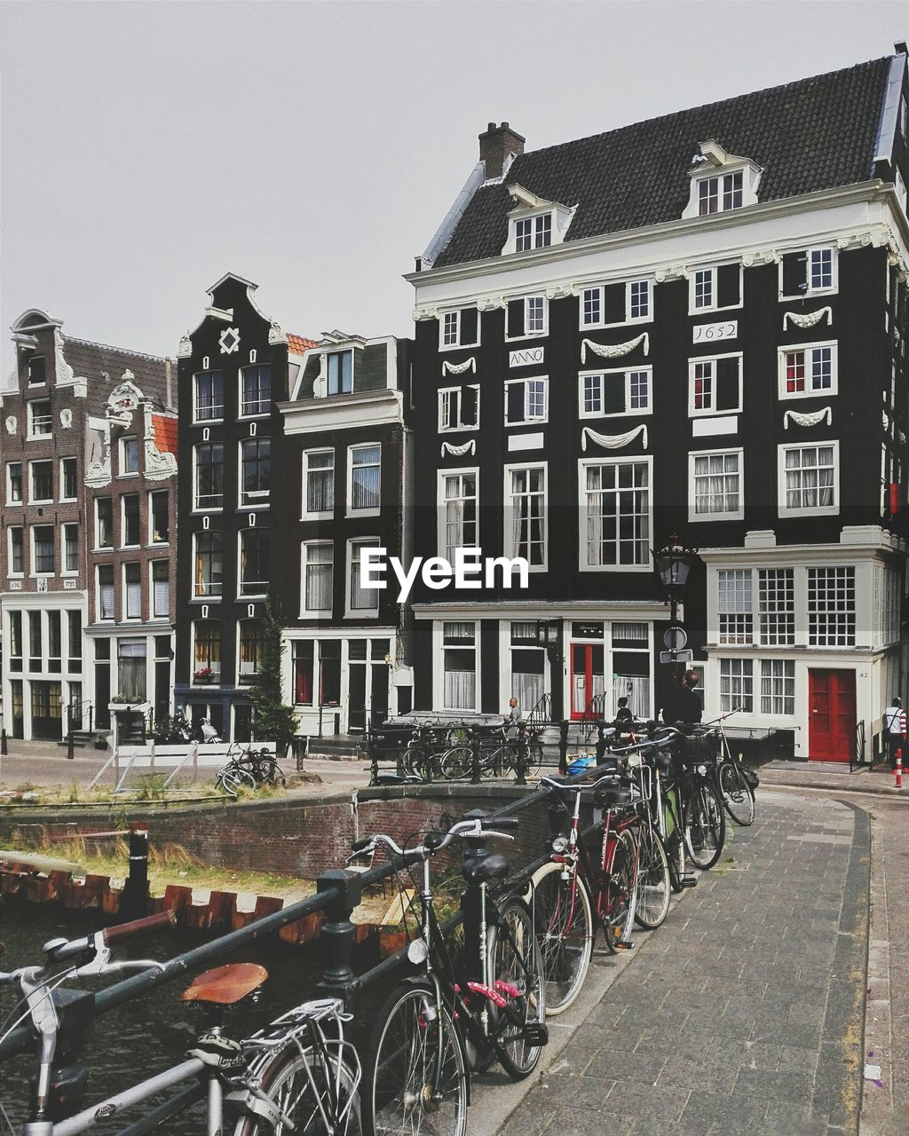 Bicycles parked on footbridge by buildings