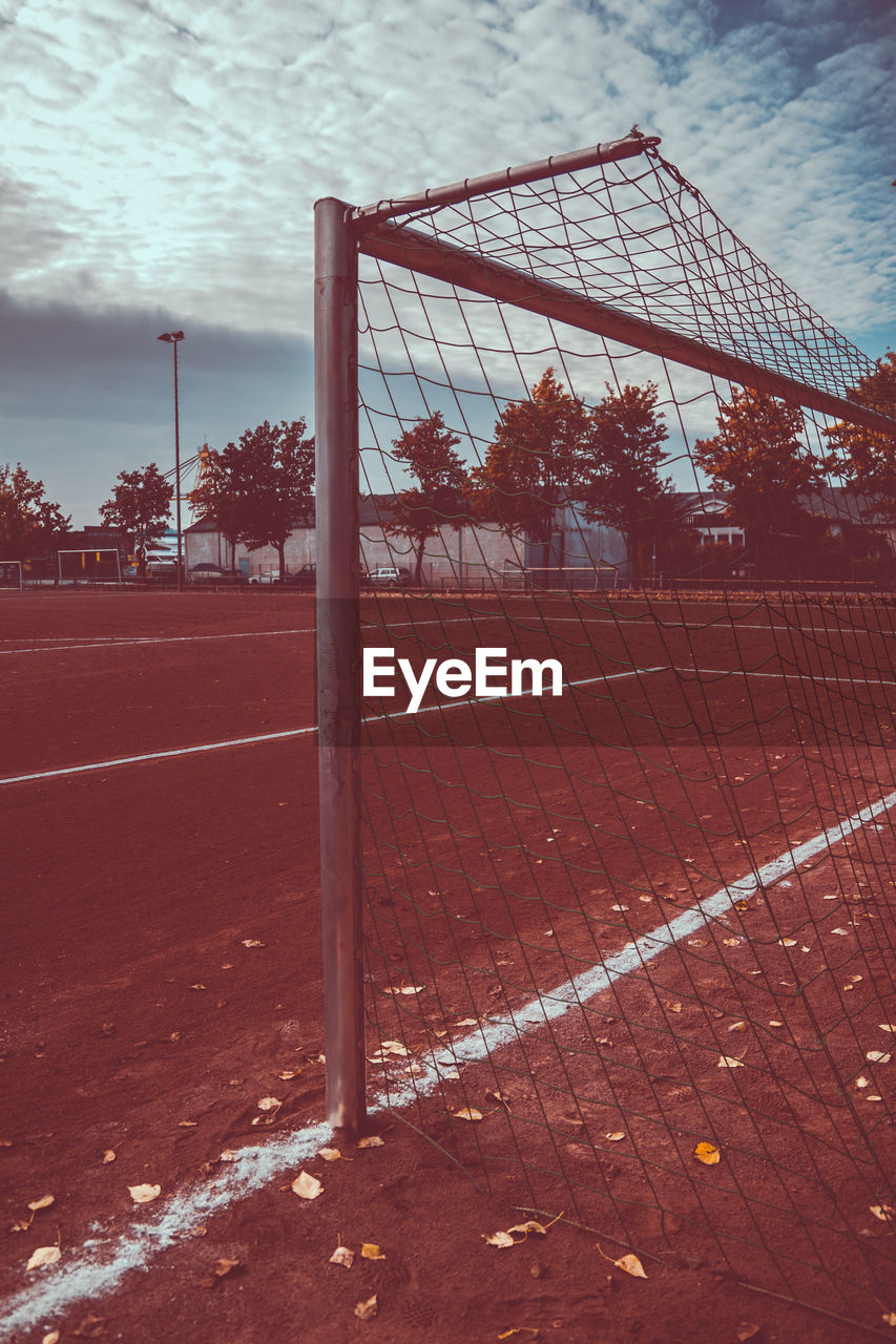 Goal post on playing field against cloudy sky