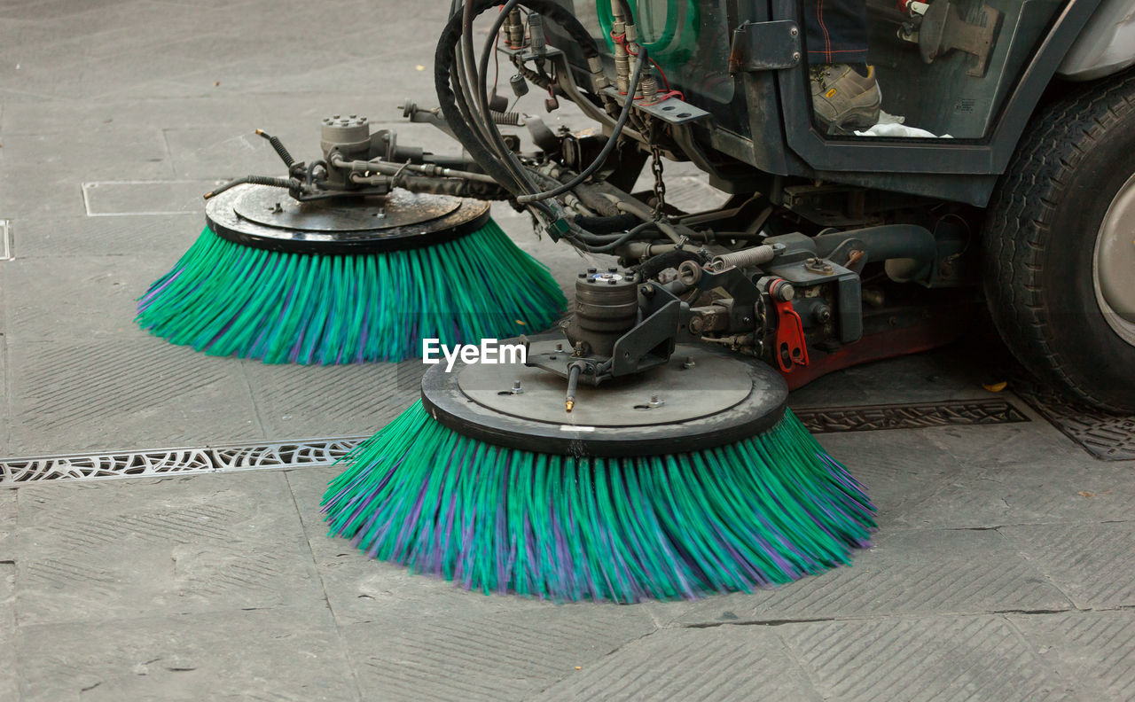 High angle view of sweeper truck cleaning footpath