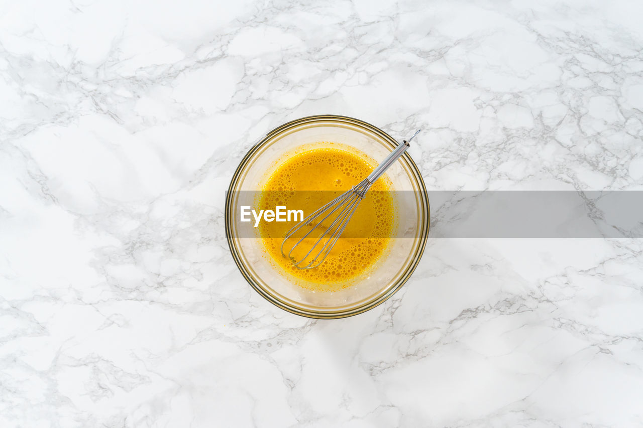 food and drink, drink, refreshment, yellow, indoors, high angle view, glass, drinking glass, studio shot, no people, food, freshness, household equipment, still life, wellbeing, cold temperature, healthy eating, directly above, frozen