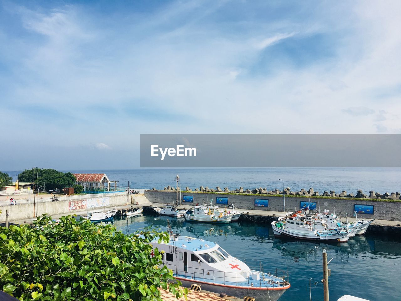 High angle view of marina and sea against sky