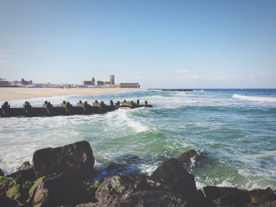 SCENIC VIEW OF SEA WITH ROCKS IN BACKGROUND