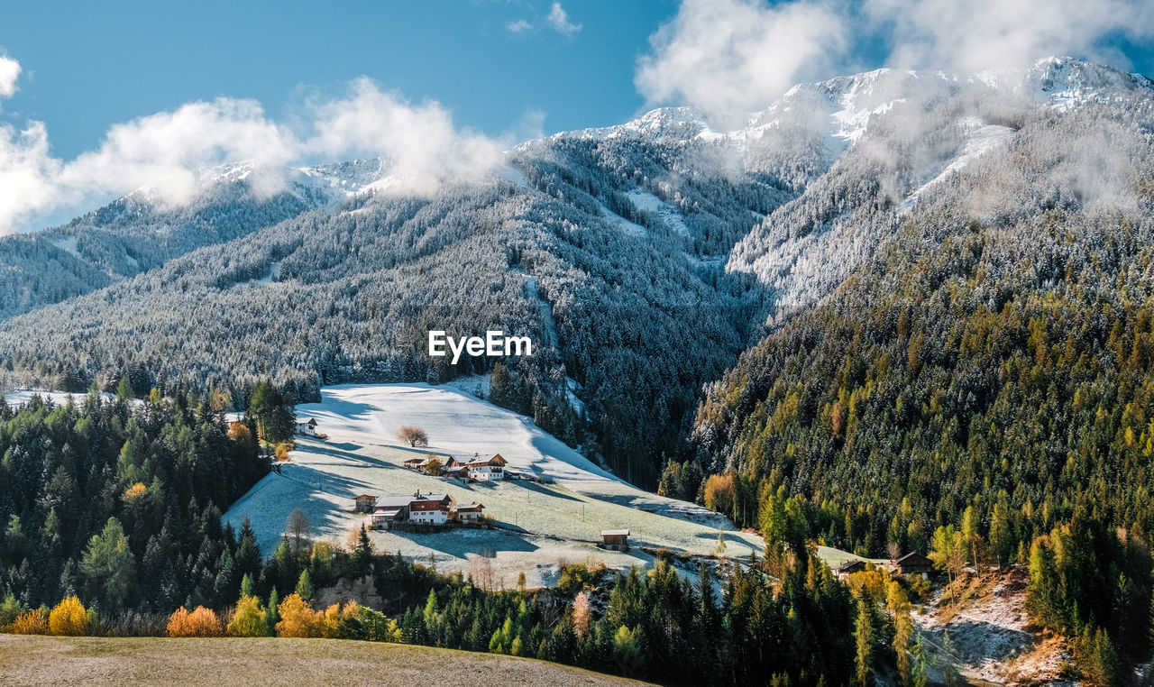 Aerial view of snowcapped mountains against sky in dolomite alps, italy.