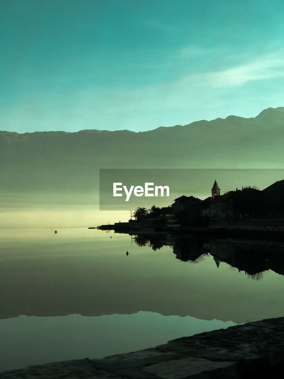 Silhouette mountains by the sea