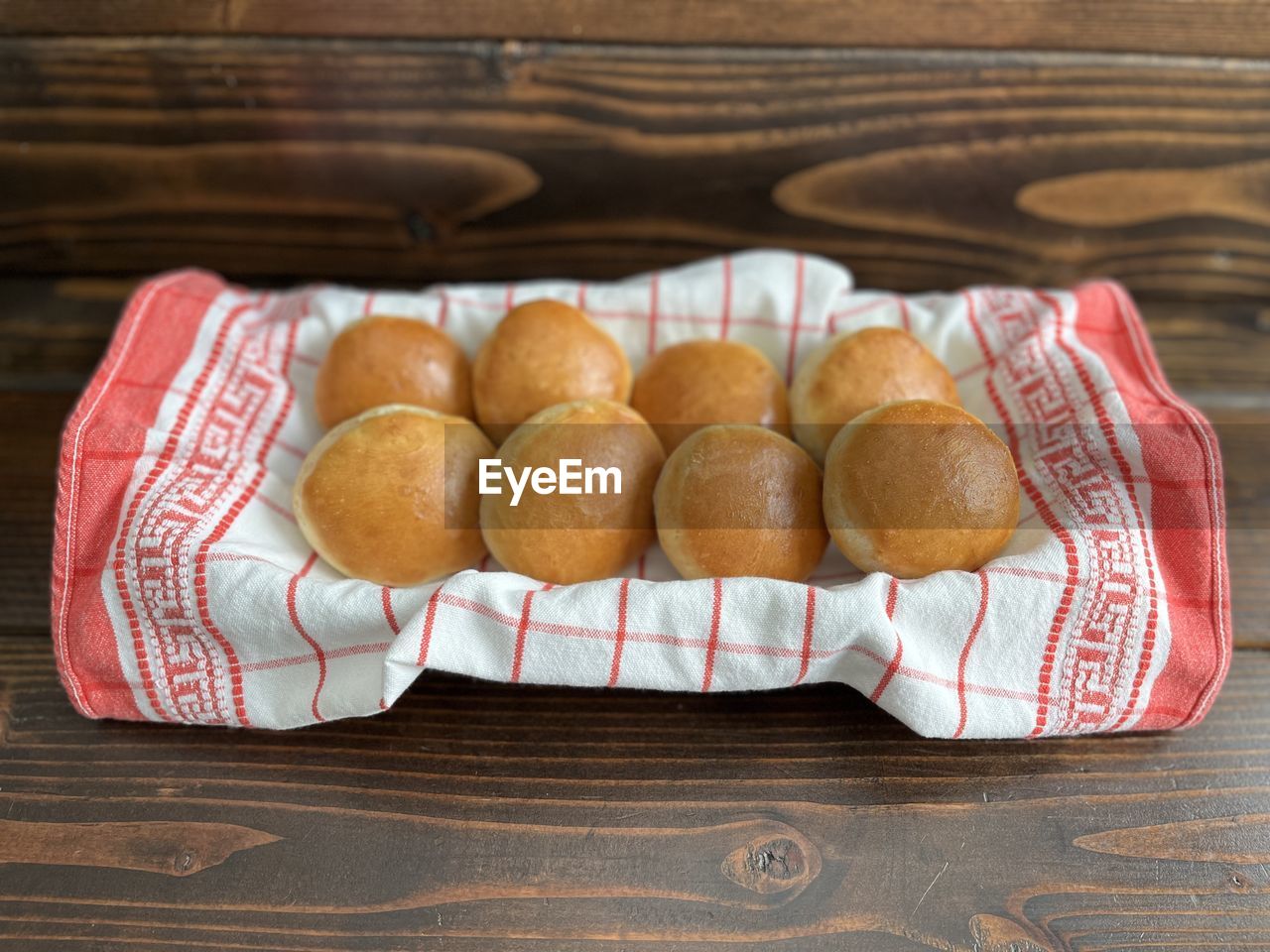 Close-up of fresh bakes buns in basket on table