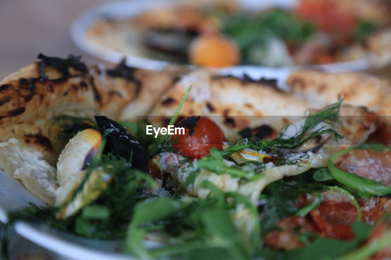 Close-up of pizza in plate on table