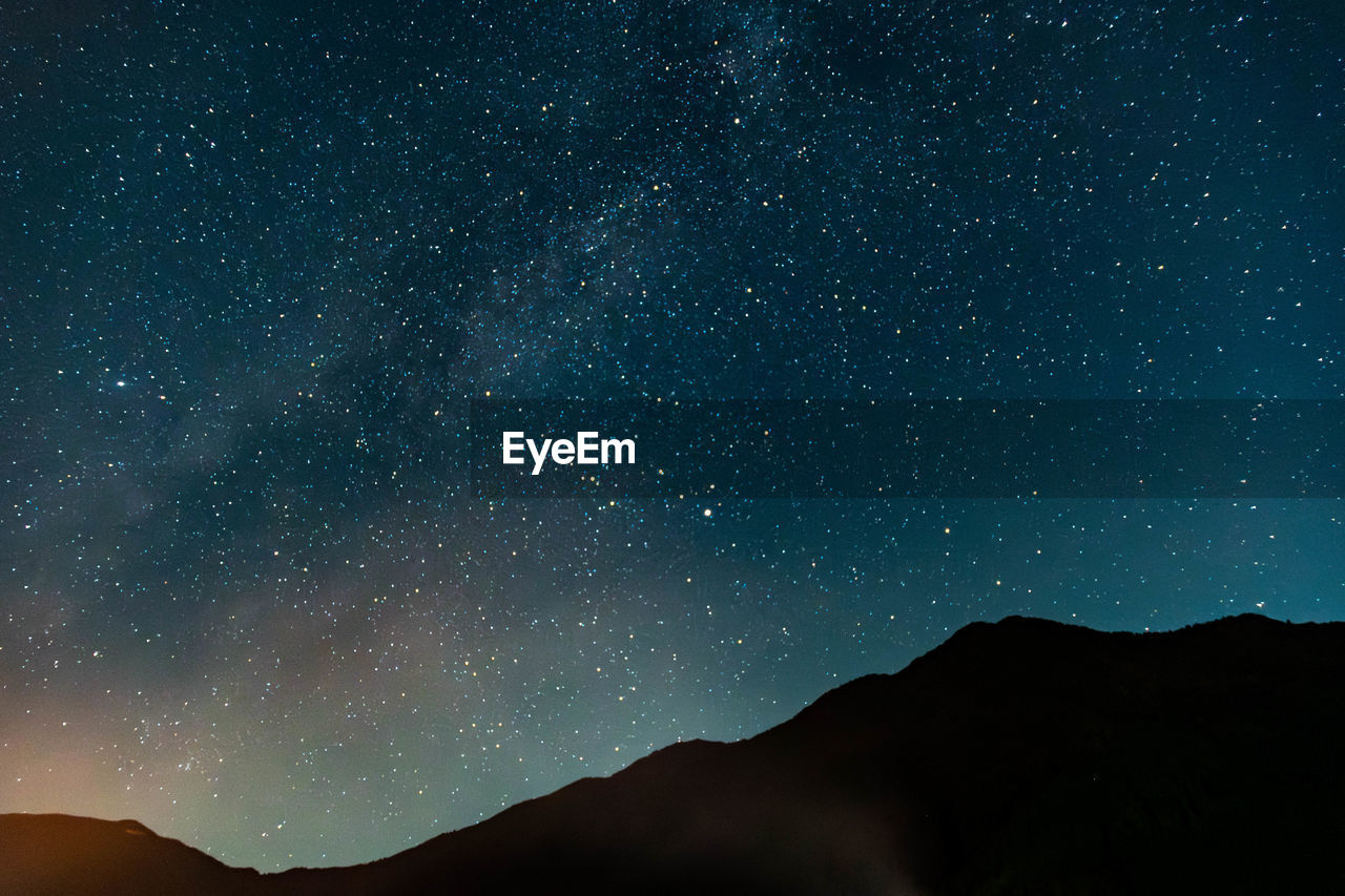 Low angle view of mountain against sky at night