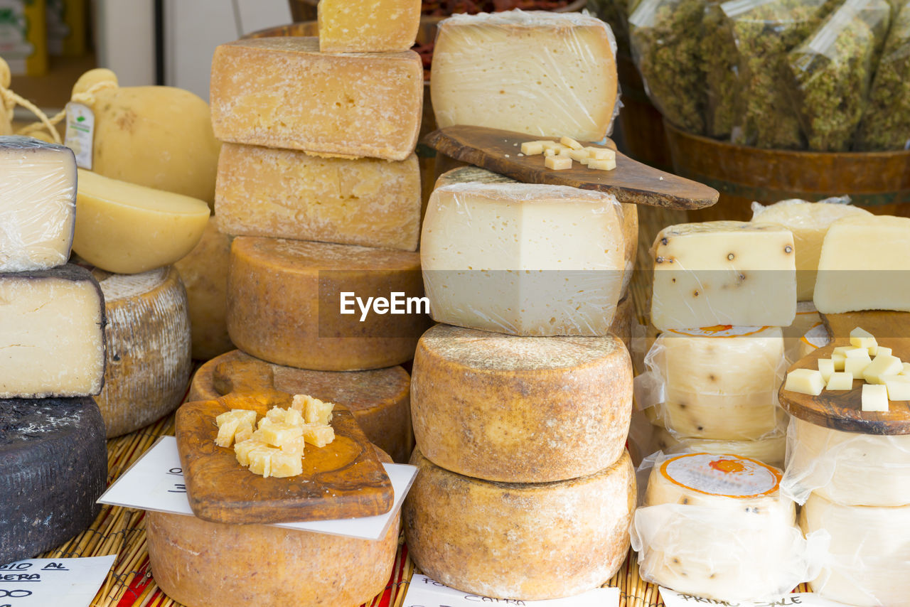 Various cheeses for sale at market stall