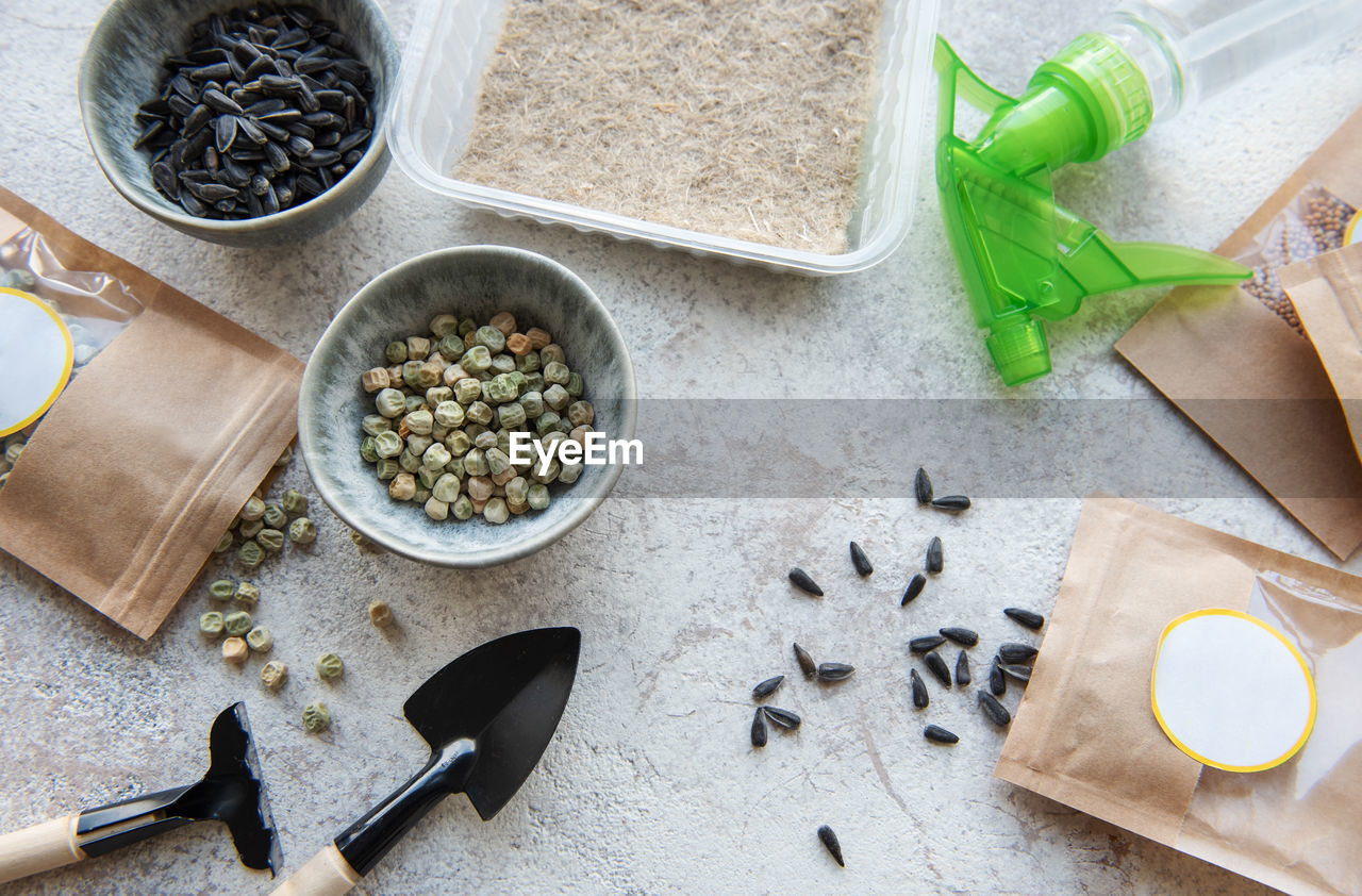 Microgreen seeds in paper bags and microgreen sowing equipment on the table. healthy food.