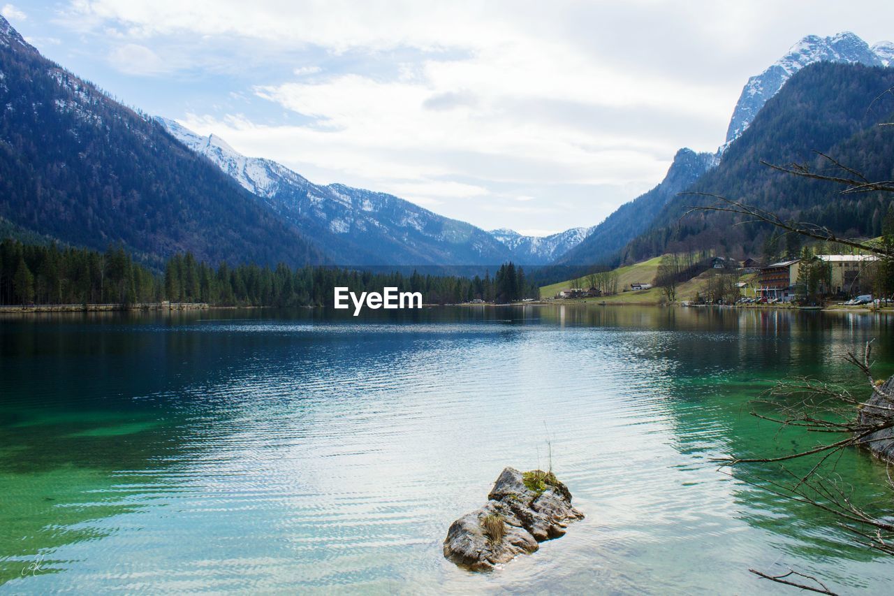 Scenic view of lake against cloudy sky