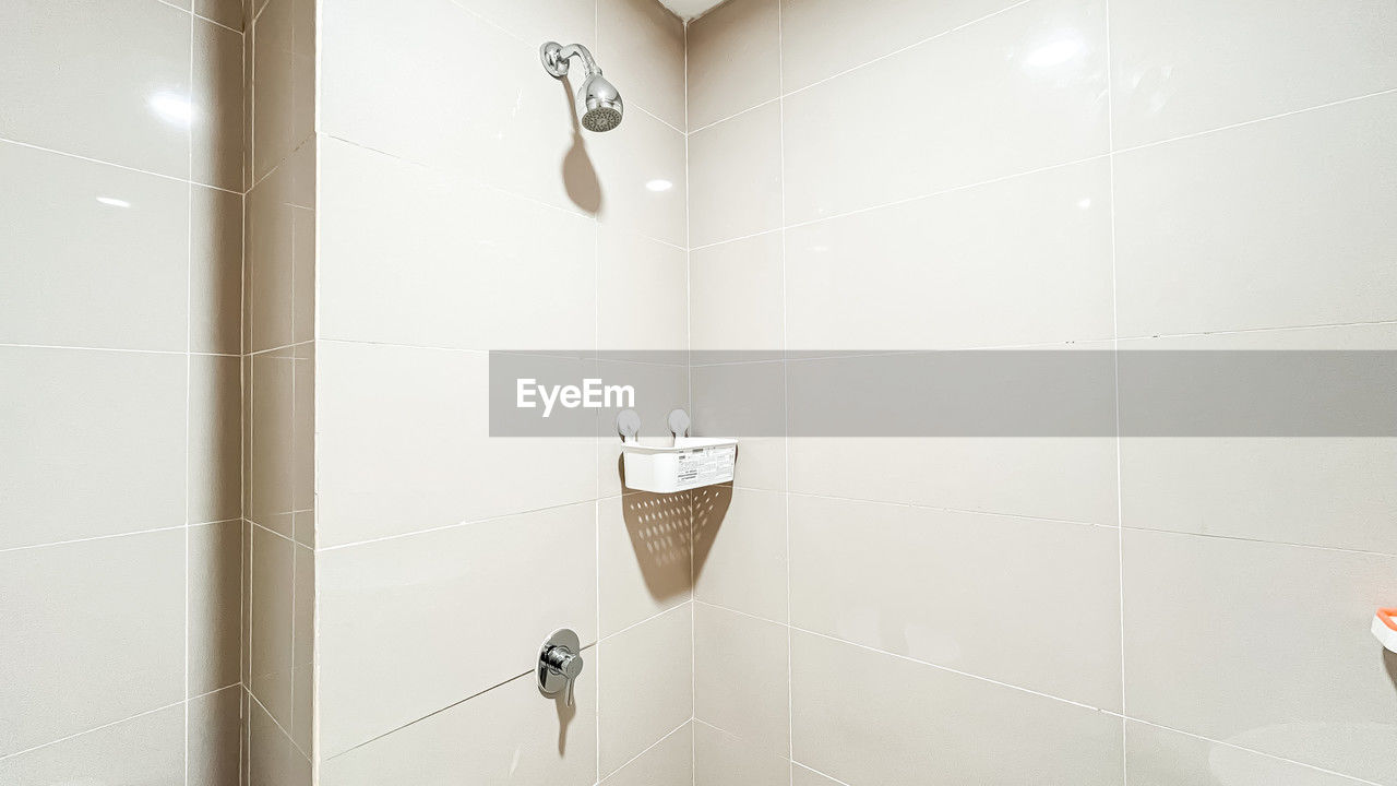 room, bathroom, floor, indoors, tile, flooring, domestic bathroom, home, domestic room, plumbing fixture, shower, no people, wall - building feature, hygiene, interior design, tiled floor, wall