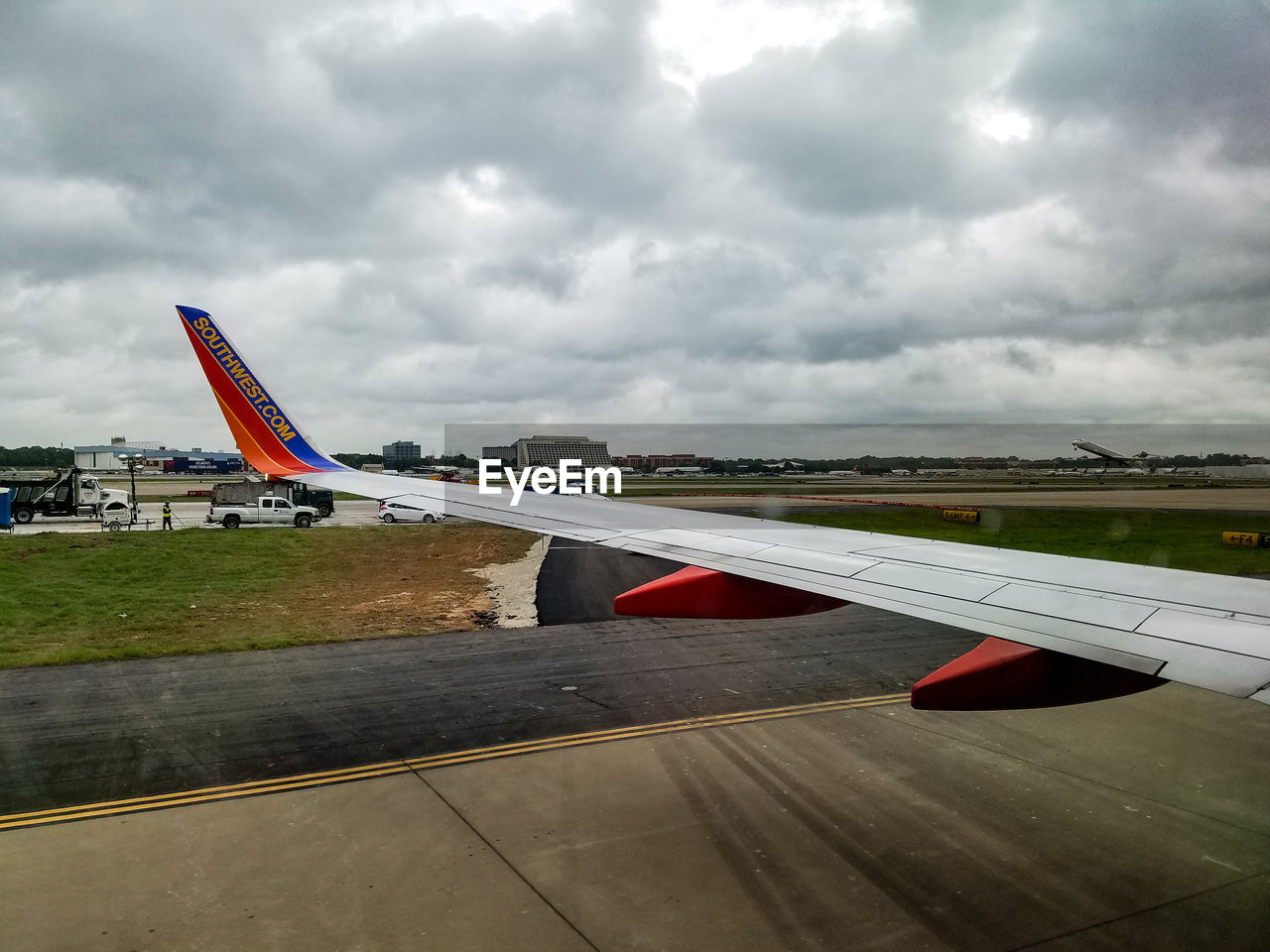 AIRPLANE ON RUNWAY AGAINST SKY