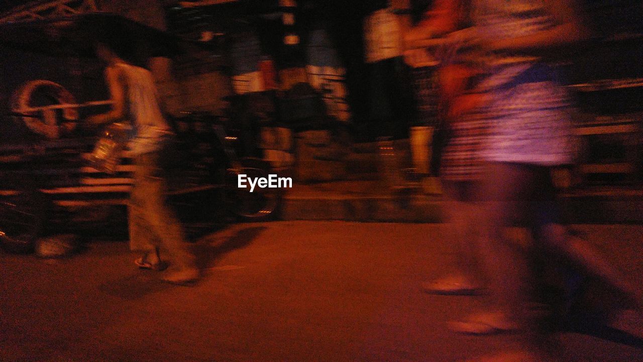 Blurred motion of people on street at night