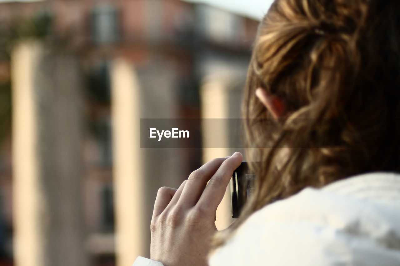 Close-up of woman photographing outdoors