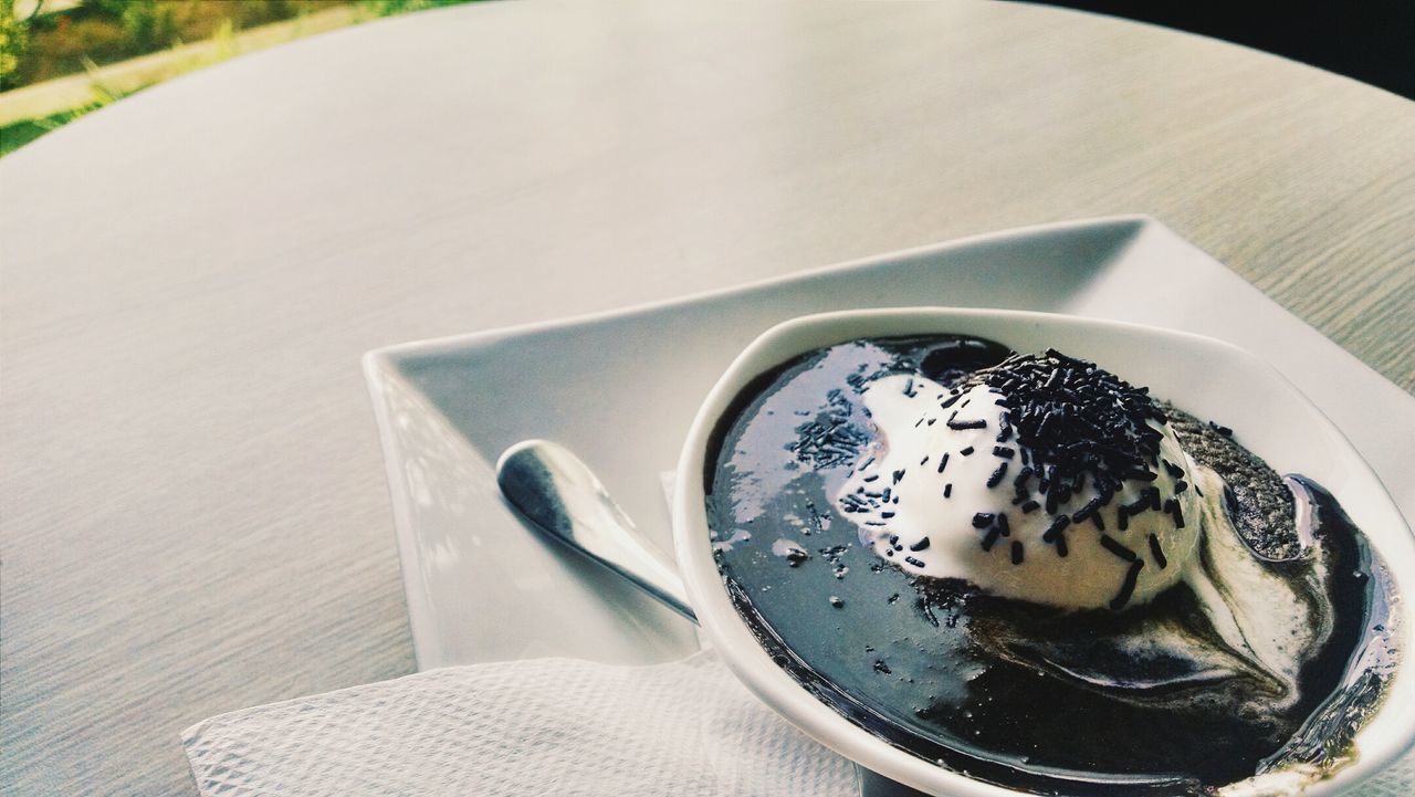 Close-up of molten lava cake with vanilla ice cream on restaurant table