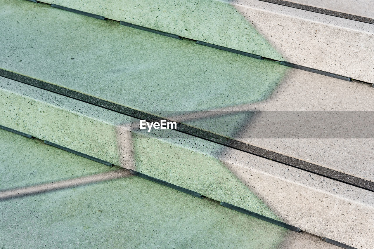 HIGH ANGLE VIEW OF SHADOW ON FOOTPATH