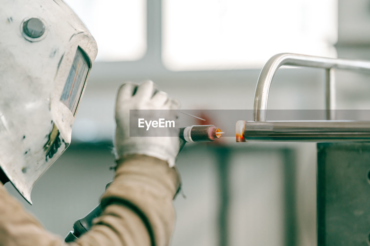 cropped hand of scientist examining patient in laboratory