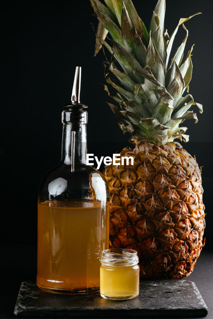 Berry tinctures in shorts with fruit and berries on the backgrou