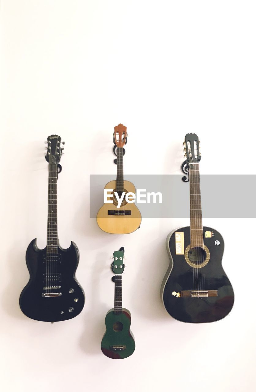 guitar, musical instrument, string instrument, music, plucked string instruments, acoustic guitar, musical equipment, acoustic-electric guitar, arts culture and entertainment, bass guitar, studio shot, white background, electric guitar, indoors, no people, font, cut out, rock music