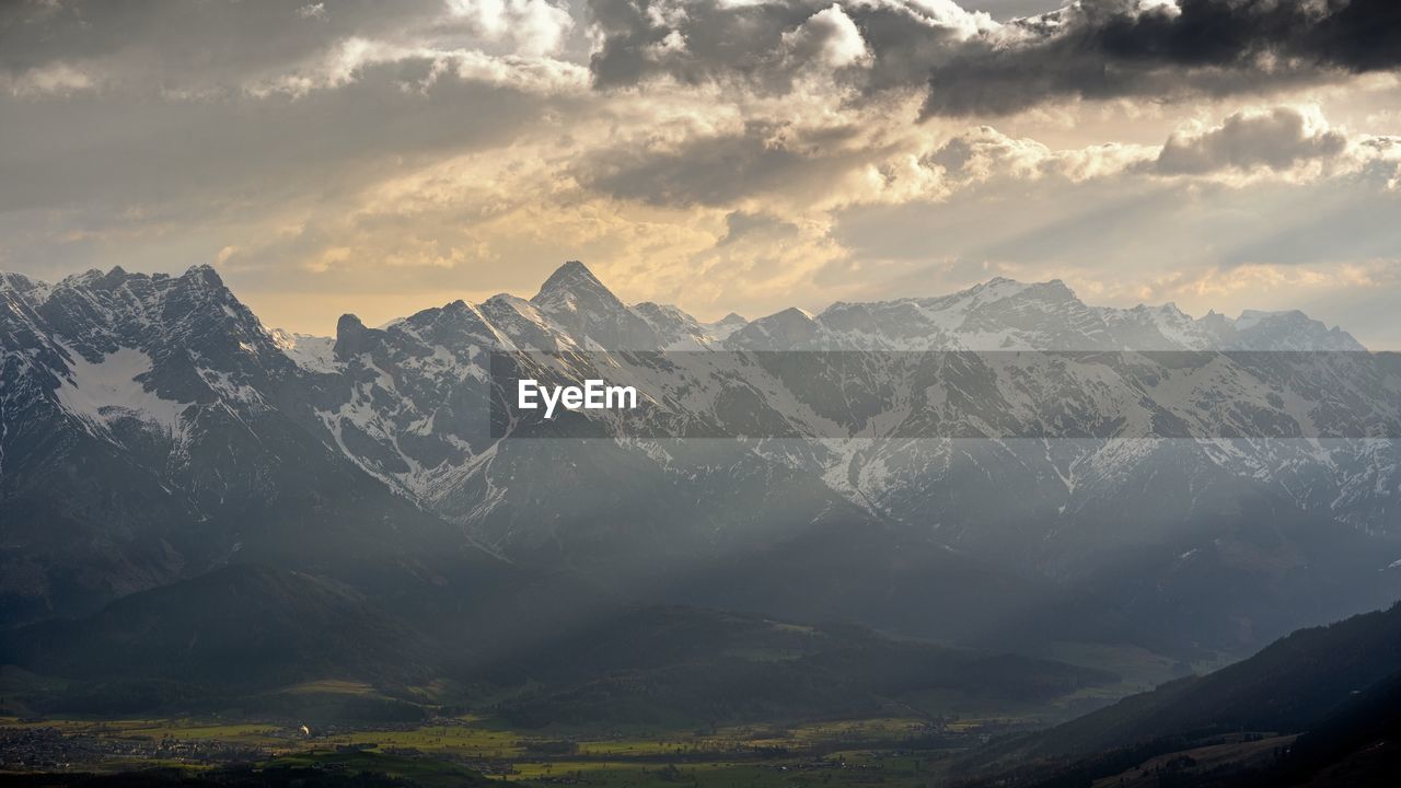 SCENIC VIEW OF SNOWCAPPED MOUNTAINS AGAINST SKY AT SUNSET