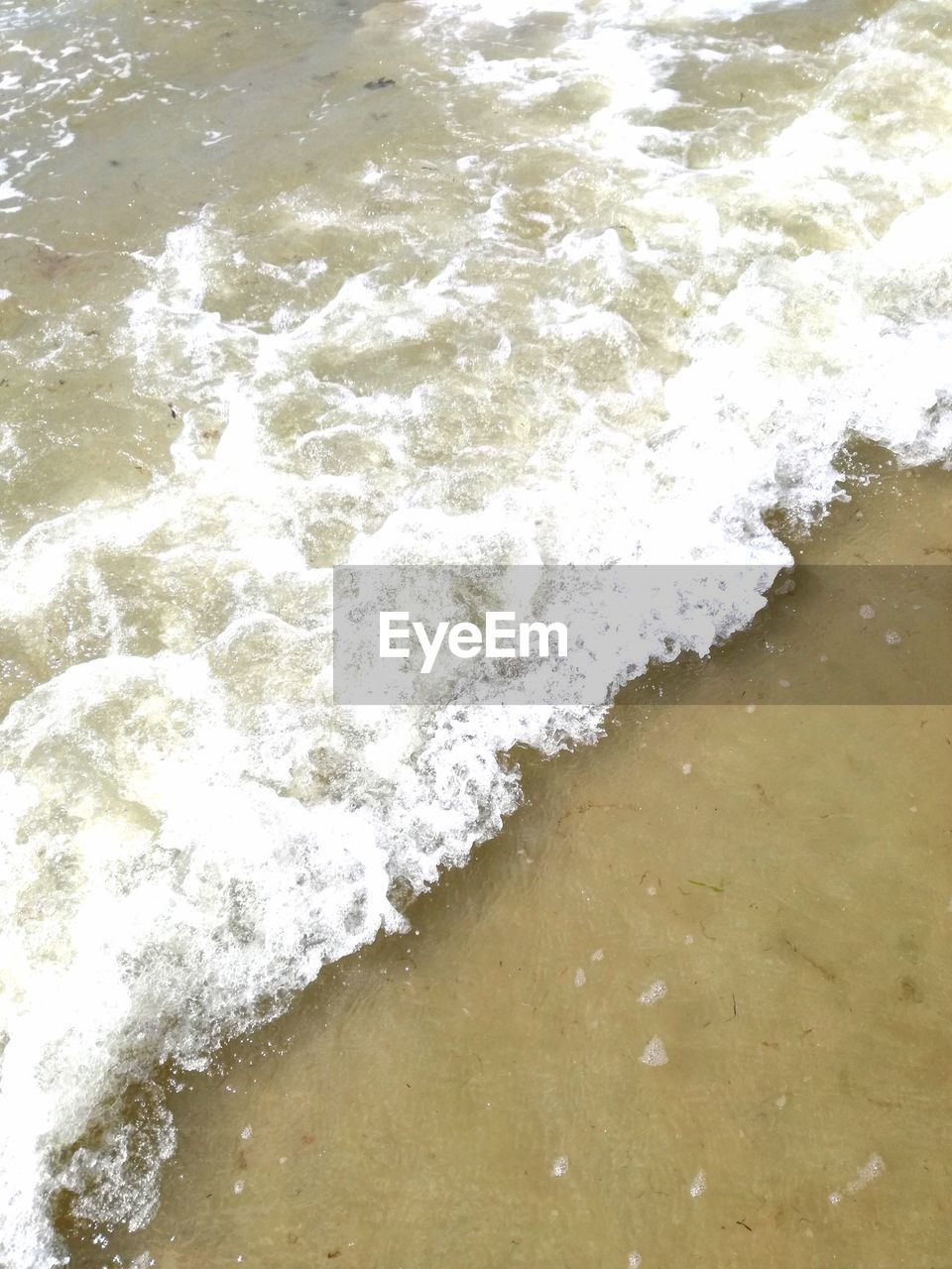 HIGH ANGLE VIEW OF WAVES ON SHORE