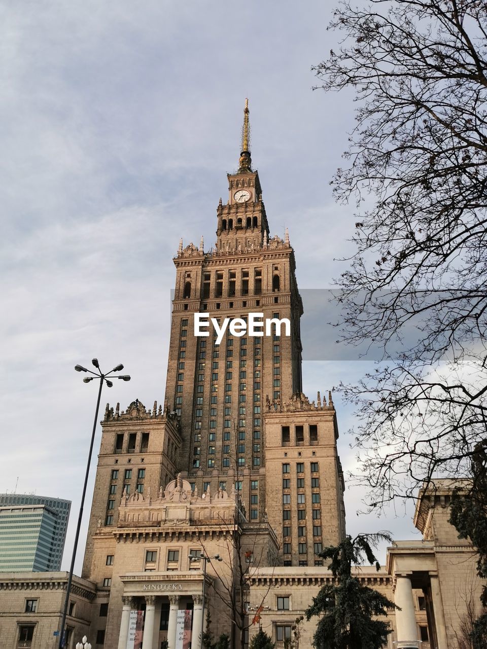 Low angle view of buildings against cloudy sky