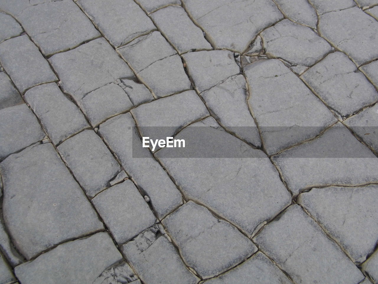 HIGH ANGLE VIEW OF COBBLESTONE