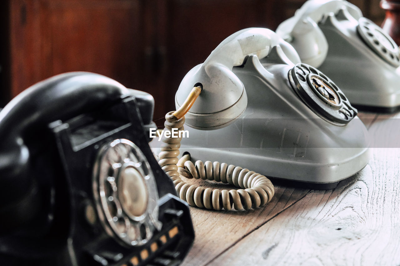 Close-up of vintage telephones on table