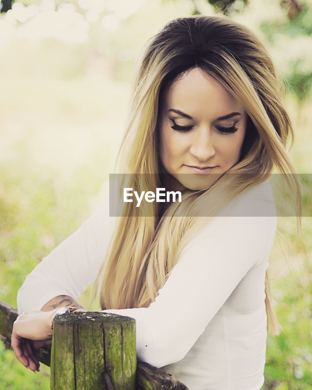 Beautiful woman looking away while standing by railing