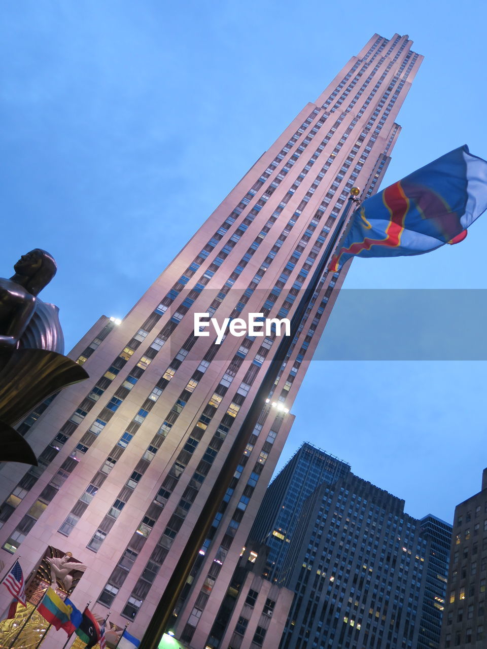 LOW ANGLE VIEW OF FLAG AGAINST BUILDINGS IN CITY