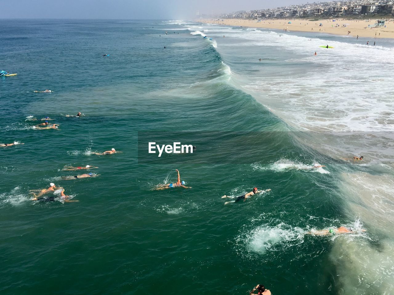 People at beach against sky