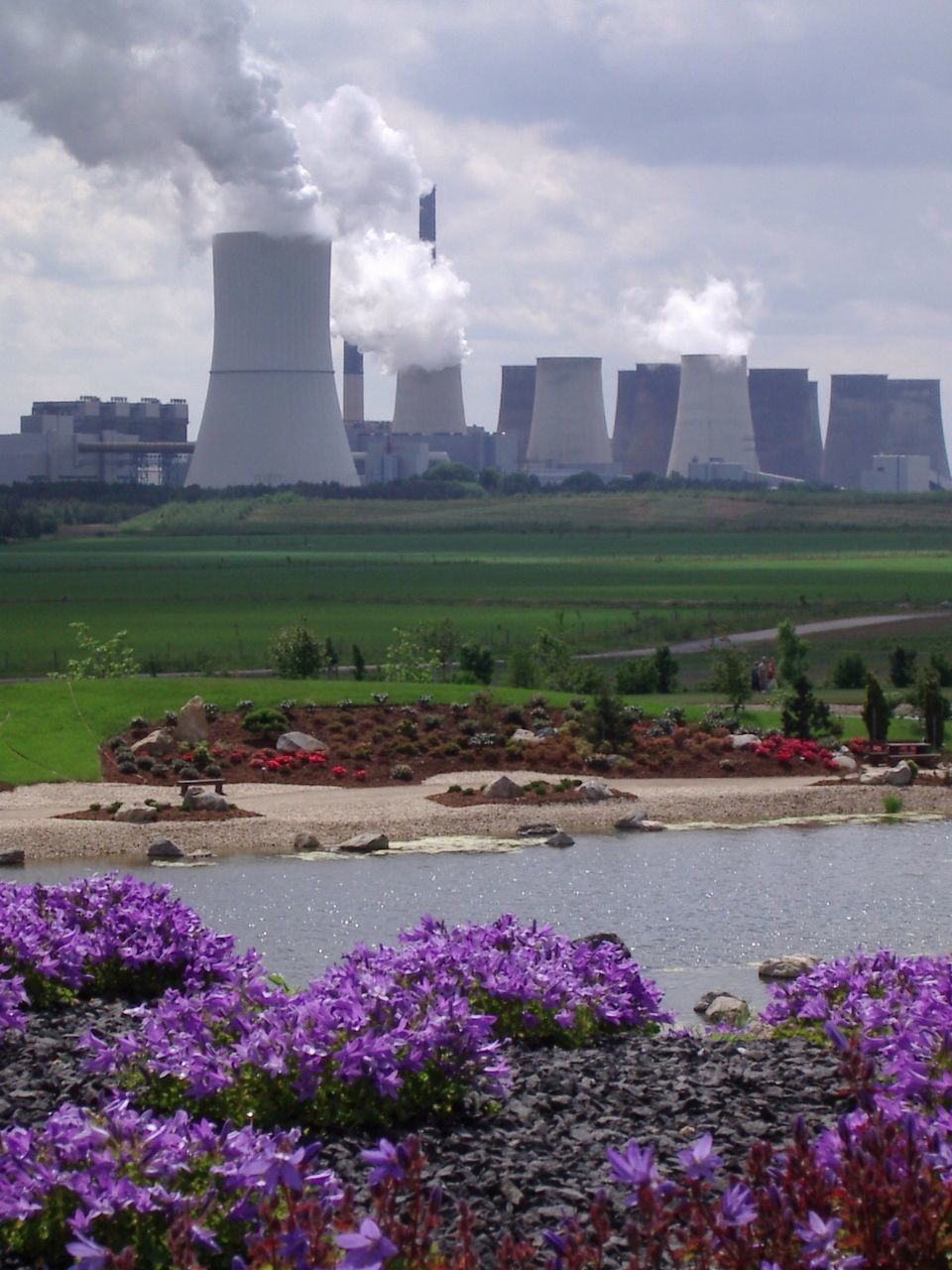 View of steaming cooling towers at nuclear power plant