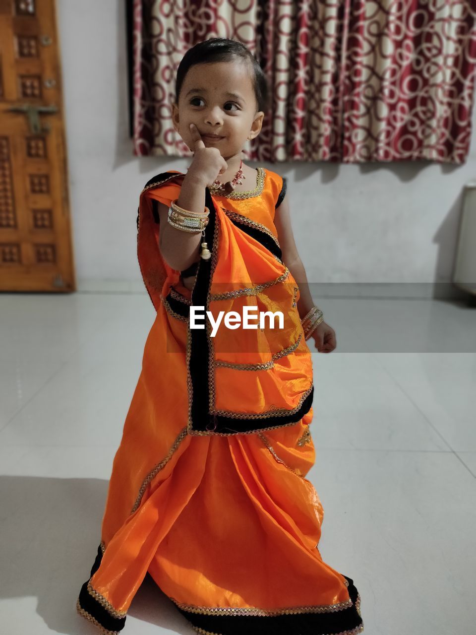 Full length of girl wearing sari standing at home